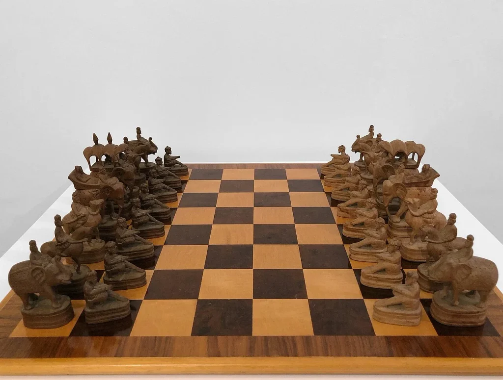 Antique carved Indian chess set with animal-mounted pieces, associated with chaturanga