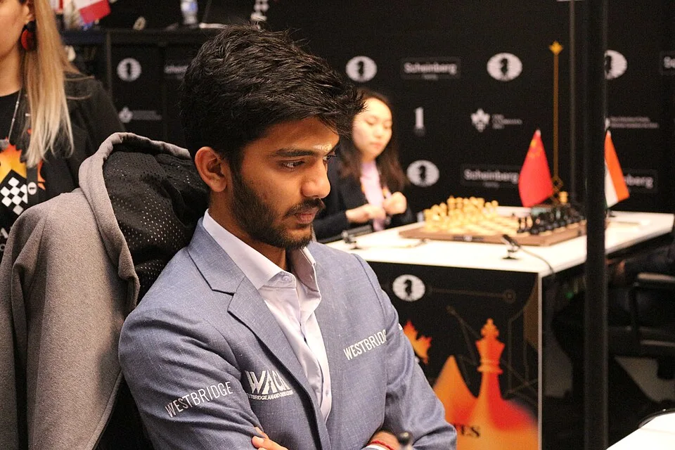 Image of Gukesh, sitting calmly, focusing on the chess board.